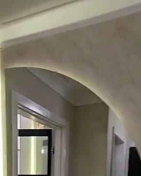 Arched hallway wall with LED halo, oak slats and a floating drawer, Leeds, built by WK Home Interiors