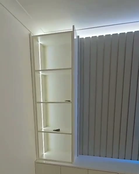 Fluted wall with blue LED TV frame and lit shelving, Cardiff, built by WK Home Interiors