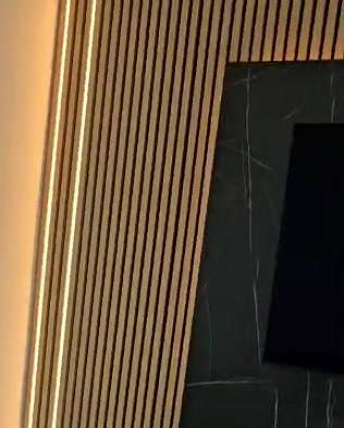 Warm-lit vertical oak slats framing a black marble TV surround