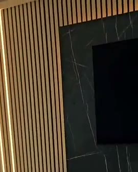 Oak slats, black marble TV surround and a built-in fire, built by WK Home Interiors