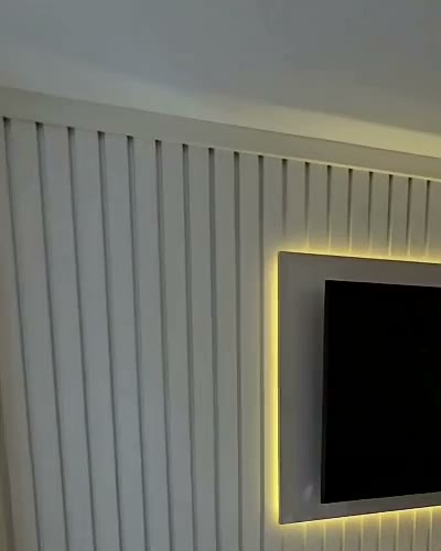 Fluted wall with lit shelf niches and LED-framed TV, Derby, built by WK Home Interiors