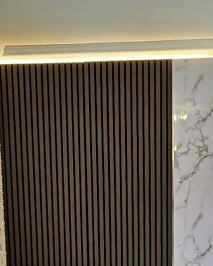 Dark oak slats, marble and stone-effect cabinets, built by WK Home Interiors